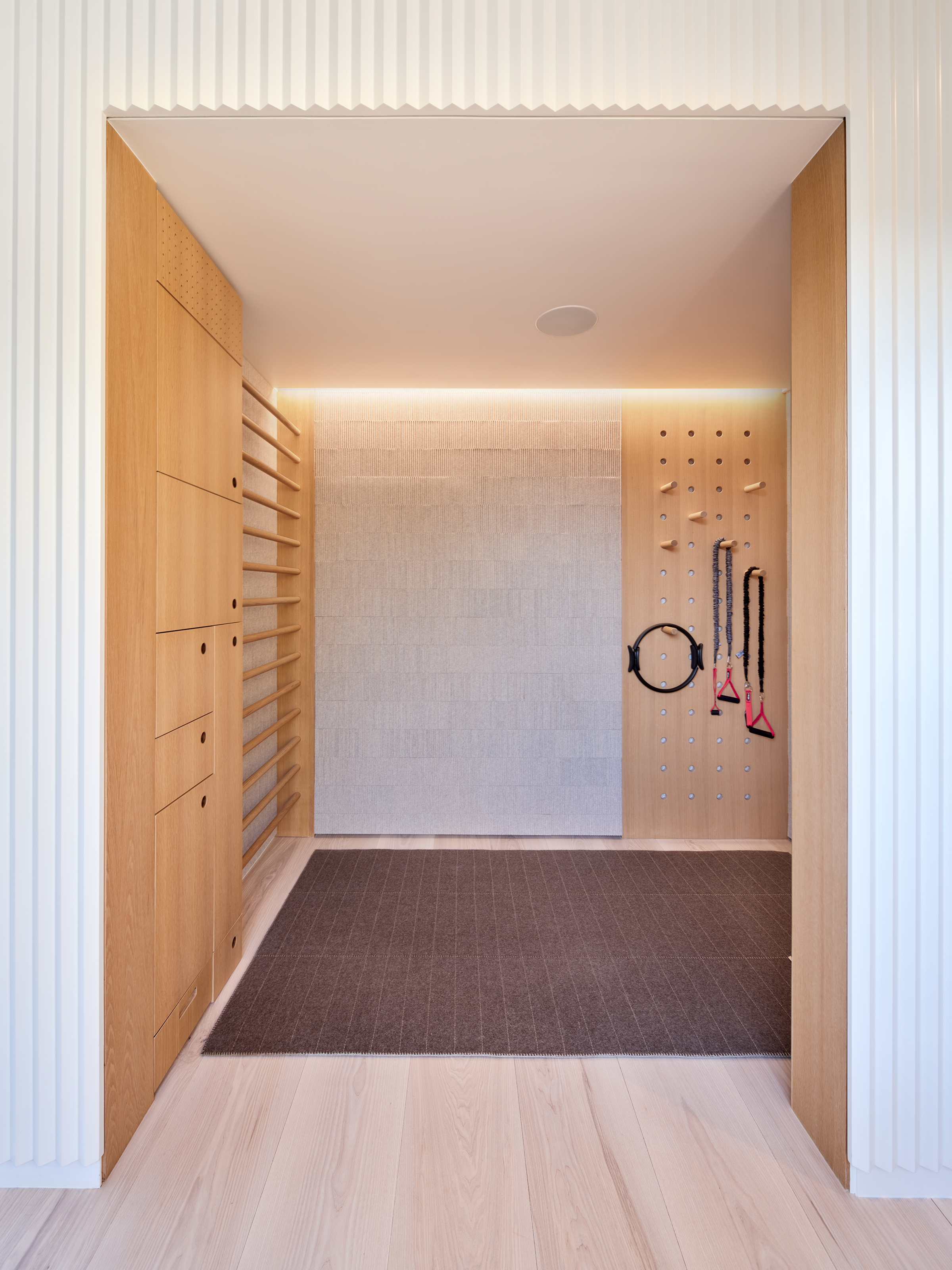 View into the exercise room integrated within the central millwork cube
