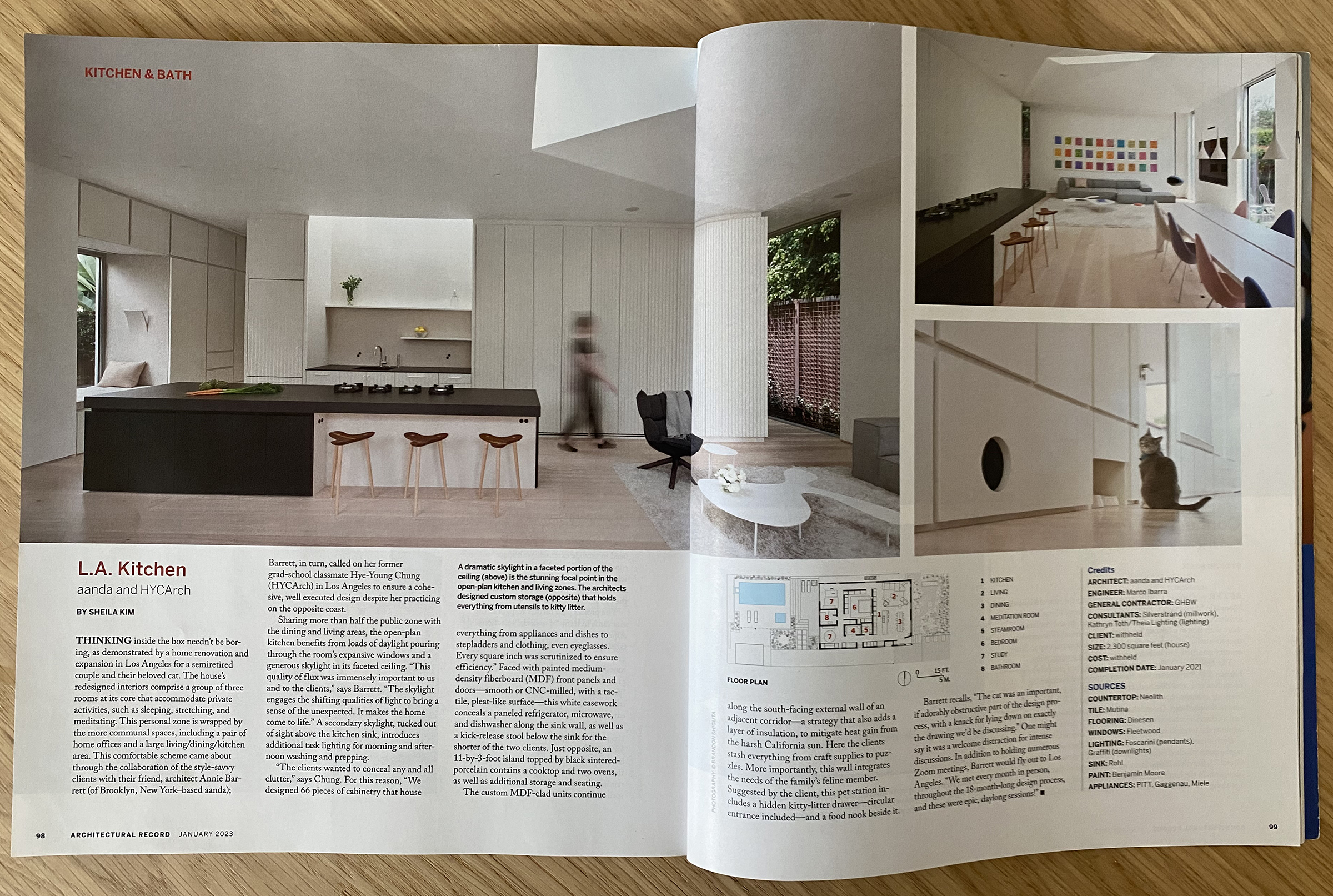 Photograph of Architectural Record magazine laying on a wooden table. The magazine is opened to an article about Centered Home.