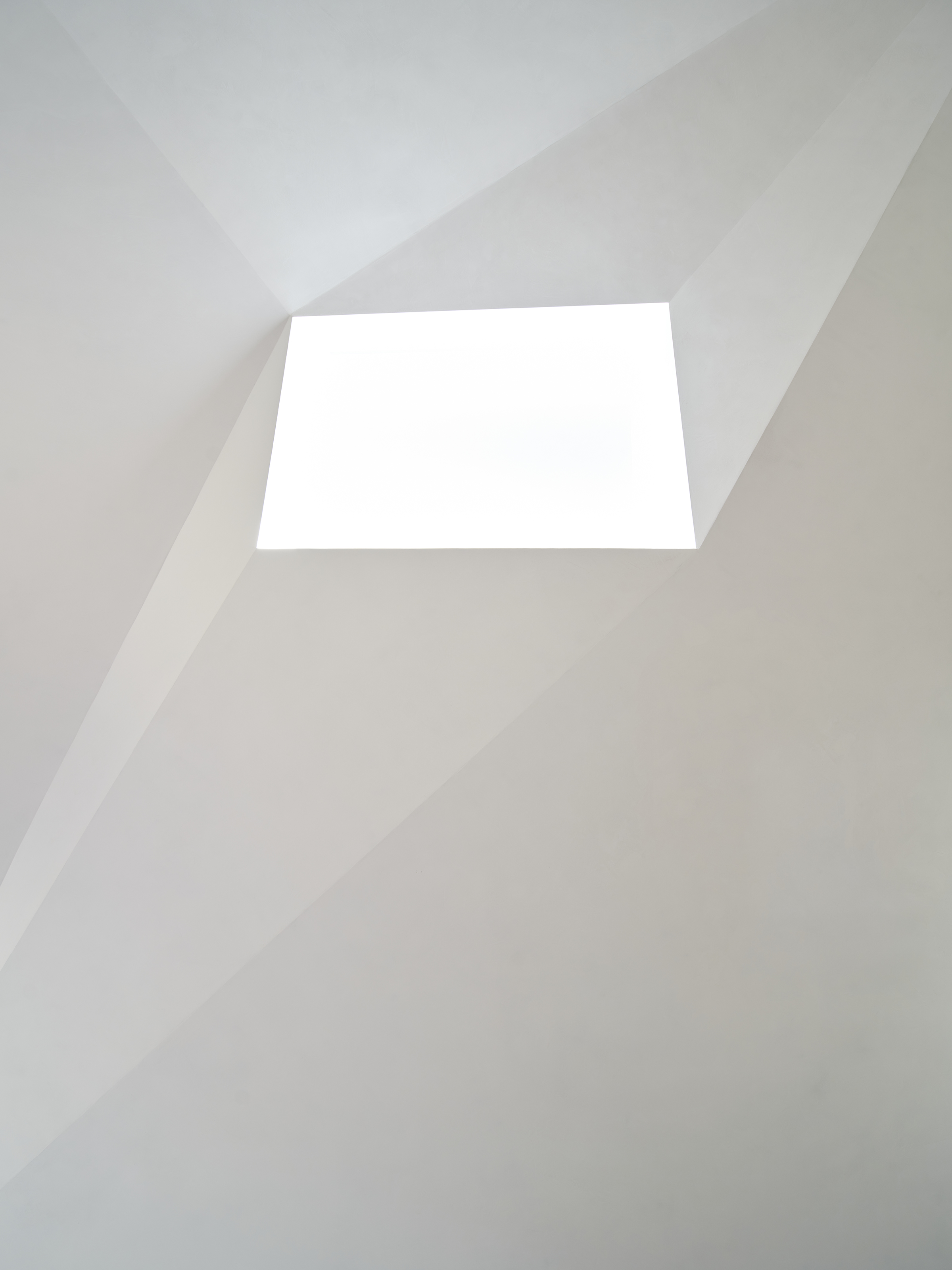 Skylight and faceted white ceiling.