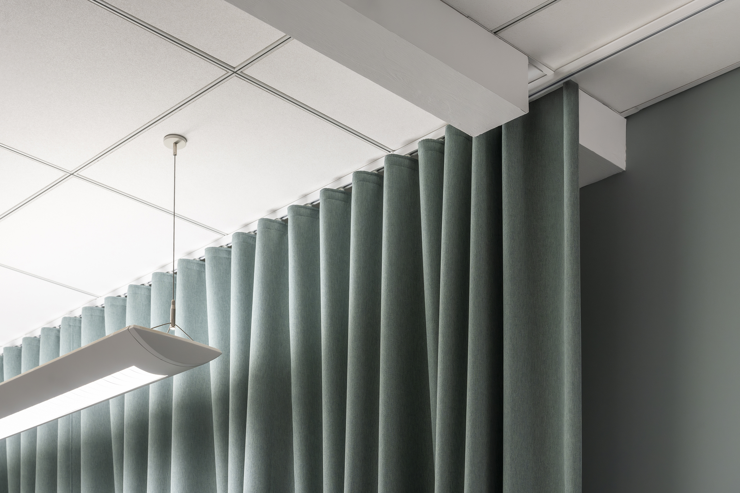 Detail view of the drapery running past a soffit detail at the ceiling